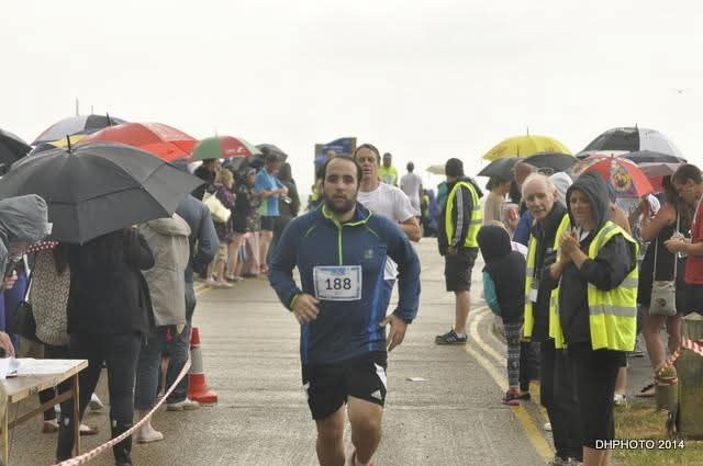 A runner finishing in the rain