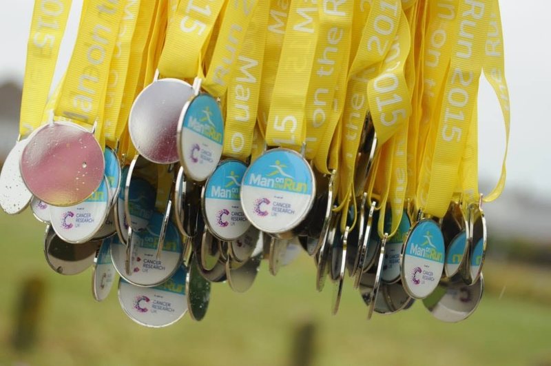 Man on the Run medals and Cancer Research UK